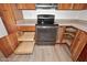 Kitchen with wooden cabinets, granite countertops, stainless steel oven, and pullout drawers, providing both style and functionality at 1861 E Bendix Dr, Tempe, AZ 85283