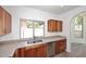 Bright kitchen featuring wood cabinetry, granite countertops, stainless steel appliances, and a large window with natural light at 1861 E Bendix Dr, Tempe, AZ 85283