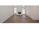 Spacious living room with wood-look tile flooring, white walls, and fireplace at 1861 E Bendix Dr, Tempe, AZ 85283