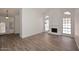 Spacious living room with wood-look tile flooring, white walls, and fireplace at 1861 E Bendix Dr, Tempe, AZ 85283