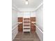 Bright walk-in closet features cedar paneling and built-in shelving, perfect for organization at 1861 E Bendix Dr, Tempe, AZ 85283