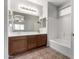 Well-lit bathroom featuring a double sink vanity and a shower-tub combo at 18719 E Pelican Ct, Queen Creek, AZ 85142
