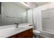 Well-lit bathroom featuring a shower-tub combination and spacious vanity with a large mirror at 18719 E Pelican Ct, Queen Creek, AZ 85142