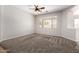 Spacious carpeted bedroom with neutral tones, a ceiling fan, and a window providing natural light at 18719 E Pelican Ct, Queen Creek, AZ 85142