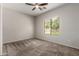 Bright bedroom features neutral walls and carpet and a large window to the outdoors at 18719 E Pelican Ct, Queen Creek, AZ 85142