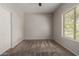 Simple bedroom with large window offering natural light and a calming view at 18719 E Pelican Ct, Queen Creek, AZ 85142