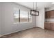 Dining area has modern light fixture, tile flooring, and lots of natural light at 18719 E Pelican Ct, Queen Creek, AZ 85142