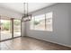 The dining area features modern lighting, and sliding doors to the backyard at 18719 E Pelican Ct, Queen Creek, AZ 85142