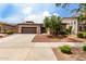 Beautiful exterior of a home featuring desert landscaping, stone accents, and a spacious driveway at 18719 E Pelican Ct, Queen Creek, AZ 85142