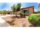 Exterior shot of a well kept home with desert landscaping, privacy shrubs and a front-facing shuttered window at 18719 E Pelican Ct, Queen Creek, AZ 85142