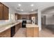 Open kitchen features wood cabinets, tile floors, and stainless steel appliances at 18719 E Pelican Ct, Queen Creek, AZ 85142