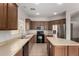 Bright kitchen with wooden cabinets, stainless refrigerator, and tile flooring at 18719 E Pelican Ct, Queen Creek, AZ 85142