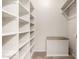 Spacious walk-in closet with ample shelving and custom storage for organized living at 18719 E Pelican Ct, Queen Creek, AZ 85142