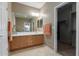 Well-maintained bathroom with a large mirror, vanity, and tile flooring at 19667 N 260Th N Ln, Buckeye, AZ 85396