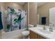 Neutral bathroom featuring a bathtub with a shower and a hummingbird shower curtain at 19667 N 260Th N Ln, Buckeye, AZ 85396