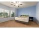 Spacious bedroom featuring carpet floors, a ceiling fan, and natural light from the windows at 19667 N 260Th N Ln, Buckeye, AZ 85396