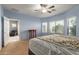 Comfortable bedroom featuring carpet floors, a ceiling fan, and bright natural light at 19667 N 260Th N Ln, Buckeye, AZ 85396