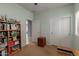 Well-organized bedroom with a bookshelf, storage, and a clear view into the hall at 19667 N 260Th N Ln, Buckeye, AZ 85396
