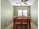 Well-lit dining room featuring tile flooring and a wooden table set for six guests at 19667 N 260Th N Ln, Buckeye, AZ 85396
