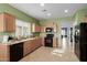 Functional kitchen with black appliances, tile flooring, and ample counter space at 19667 N 260Th N Ln, Buckeye, AZ 85396