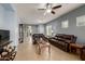 Open concept living room with tile floors, neutral walls, and leather furniture set at 19667 N 260Th N Ln, Buckeye, AZ 85396