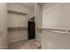 Spacious walk-in closet with shelves and a secure safe for valuables at 19667 N 260Th N Ln, Buckeye, AZ 85396
