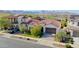 Stunning aerial view of a home with a tile roof and a manicured front lawn against a mountain backdrop at 20510 W White Rock Rd, Buckeye, AZ 85396