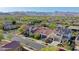 Wide aerial view of neighborhood homes with terracotta tile roofs and picturesque mountain backdrop at 20510 W White Rock Rd, Buckeye, AZ 85396