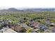 Aerial shot of a community with landscaped lawns, desert trees, and mountain views at 20510 W White Rock Rd, Buckeye, AZ 85396