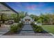 Enjoy this private backyard complete with covered pergola, fireplace, outdoor kitchen and manicured landscaping at 20510 W White Rock Rd, Buckeye, AZ 85396