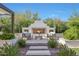 Outdoor fireplace with seating area, beautiful landscaping and pathway leading to backyard at 20510 W White Rock Rd, Buckeye, AZ 85396