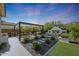 Enjoy this private backyard complete with covered pergola, fireplace, outdoor kitchen and manicured landscaping at 20510 W White Rock Rd, Buckeye, AZ 85396