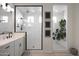 Bright bathroom featuring double vanity, glass shower, and separate tub with hanging plant at 20510 W White Rock Rd, Buckeye, AZ 85396