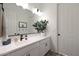 Bright bathroom vanity with decorative mirror and door leading to toilet room at 20510 W White Rock Rd, Buckeye, AZ 85396