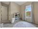 Neutral ' bedroom with a window, white door, and a house-shaped bookshelf filled with toys at 20510 W White Rock Rd, Buckeye, AZ 85396