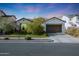 Charming single-story home boasting a well-manicured lawn, desert landscaping, and a two-car garage at 20510 W White Rock Rd, Buckeye, AZ 85396