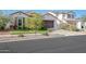Charming home featuring a well-manicured lawn, lovely landscaping, and a two-car garage at 20510 W White Rock Rd, Buckeye, AZ 85396