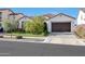 Beautiful home with a well-kept front yard, a dark two-car garage, and lovely curb appeal at 20510 W White Rock Rd, Buckeye, AZ 85396
