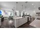 Open-concept kitchen with a large island, pendant lighting, and views into the living and dining areas at 20510 W White Rock Rd, Buckeye, AZ 85396