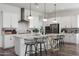 Modern kitchen features white cabinets, stainless steel appliances, and a center island with bar seating at 20510 W White Rock Rd, Buckeye, AZ 85396
