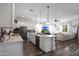 Bright, open kitchen with white cabinets, stainless steel appliances, and a view of the living room at 20510 W White Rock Rd, Buckeye, AZ 85396