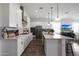 Well-lit modern kitchen with white cabinetry, stainless steel appliances, and a central island at 20510 W White Rock Rd, Buckeye, AZ 85396