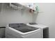 Bright laundry room with front load washer and dryer plus organized overhead shelving at 20510 W White Rock Rd, Buckeye, AZ 85396