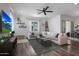 Cozy living room features a large sectional sofa, ceiling fan, and open design at 20510 W White Rock Rd, Buckeye, AZ 85396