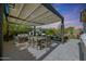 Outdoor patio features a pergola, a dining table, comfortable seating, and an inviting outdoor fireplace at 20510 W White Rock Rd, Buckeye, AZ 85396