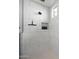 Bright shower featuring white tile walls, recessed niche, and rainfall shower head at 20510 W White Rock Rd, Buckeye, AZ 85396