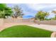 Lush backyard featuring artificial turf, desert landscaping, and privacy fencing perfect for outdoor enjoyment at 20929 N 37Th Way, Phoenix, AZ 85050
