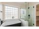 Modern bathroom featuring a sleek tub and glass-enclosed shower at 20929 N 37Th Way, Phoenix, AZ 85050