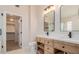 Elegant bathroom featuring double sinks and wood cabinetry at 20929 N 37Th Way, Phoenix, AZ 85050