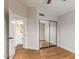Bedroom showcasing wood floors and mirrored closet doors at 20929 N 37Th Way, Phoenix, AZ 85050